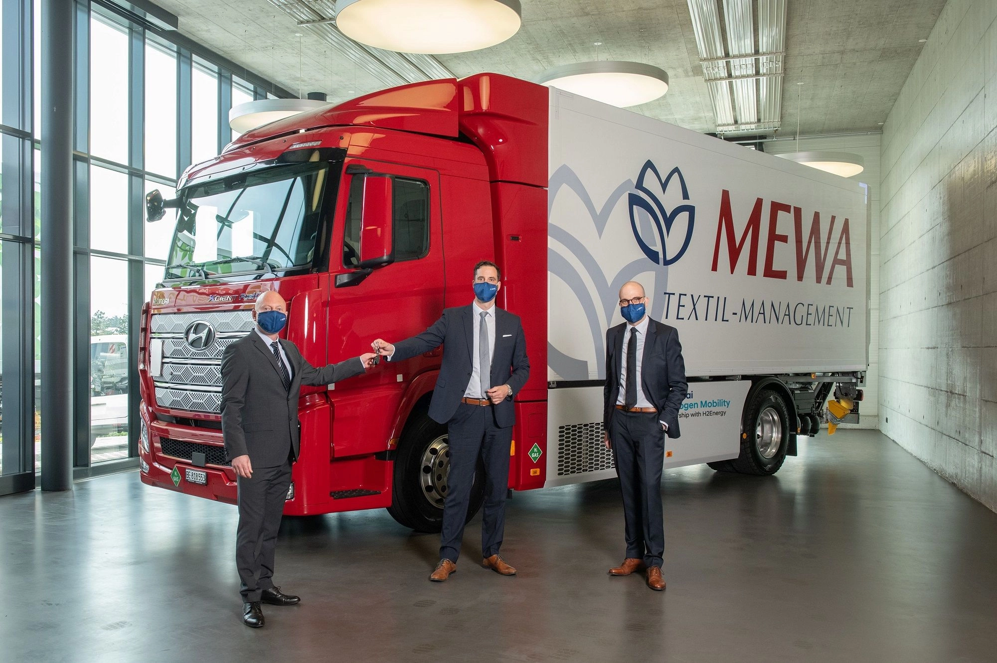 A Mewa recebe o primeiro camião a hidrogénio da Hyundai. Da esq. para a dir.: George Lazar, MEWA Suíça, Mark Freymüller, Hyundai HM, Kay Simon, MEWA Wiesbaden (foto: MEWA)